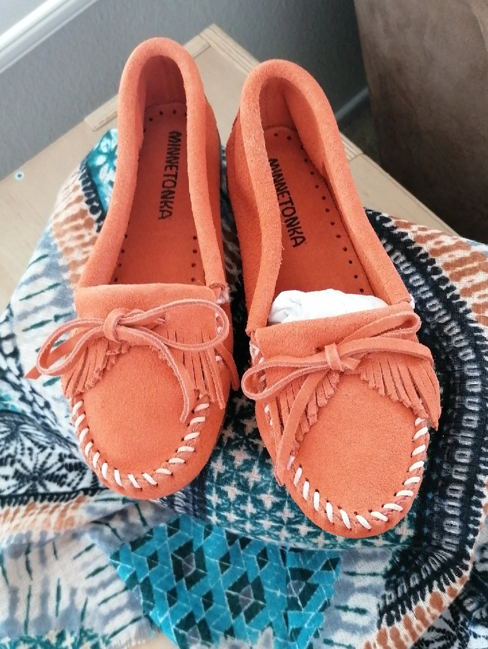 Minnetonka  Orange soft suede hard sole Moccasin.Never worn. Runs  big 5.5 = 6.5